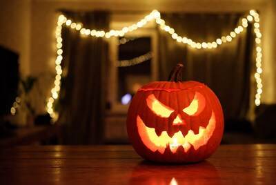Lit Jack-o'-Lantern on Wooden Table