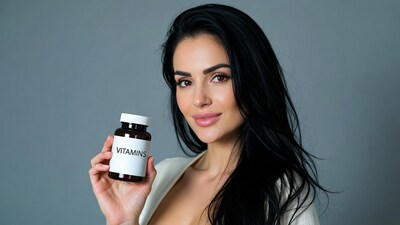 Woman holding vitamins bottle