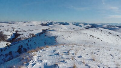 Snowy Hills Landscape Under Blue Sky