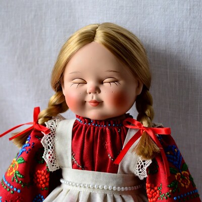 Blonde girl doll in embroidered dress