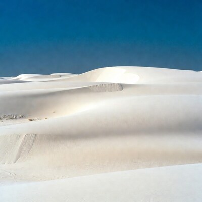 White sand dunes under blue sky