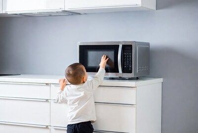 Toddler reaching for microwave
