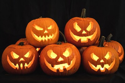 Stack of lit jack-o-lantern pumpkins