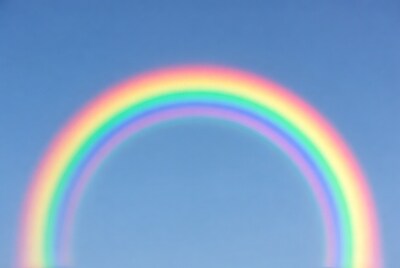 Vibrant Rainbow in Blue Sky