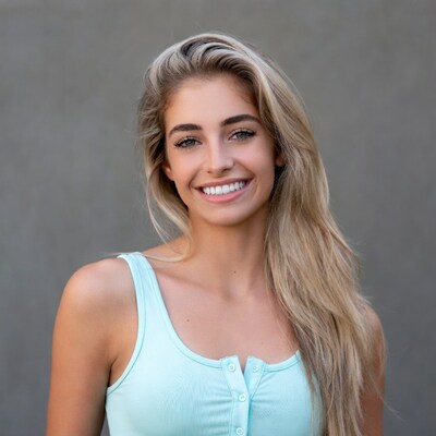 Smiling blonde woman in blue tank top