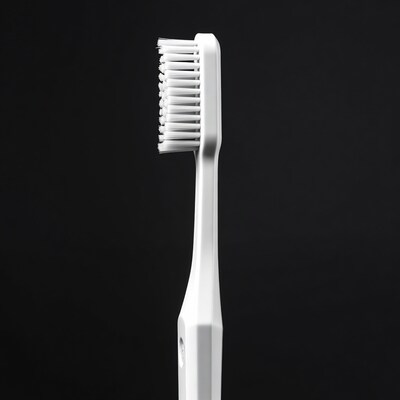 White toothbrush on black background