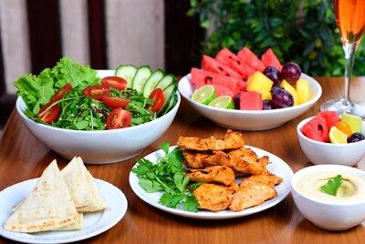 Fresh salad fruit platter with chicken and hummus