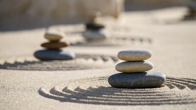 Stacked rocks on sand with ripples