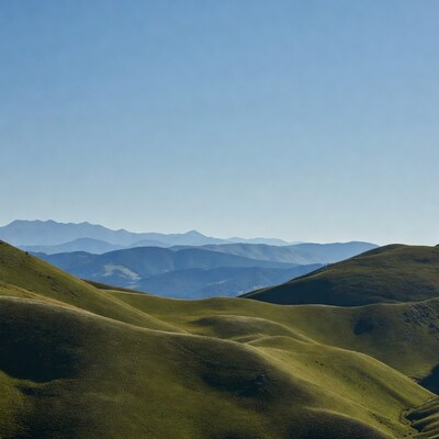 Green Rolling Hills and Distant Mountains