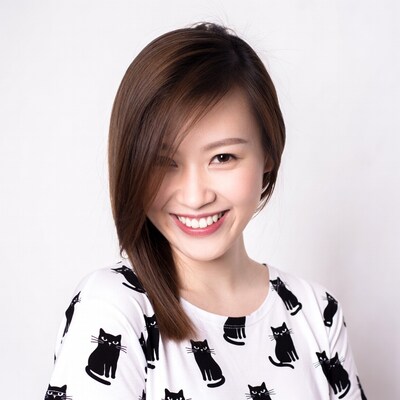 Asian woman smiling in cat print shirt