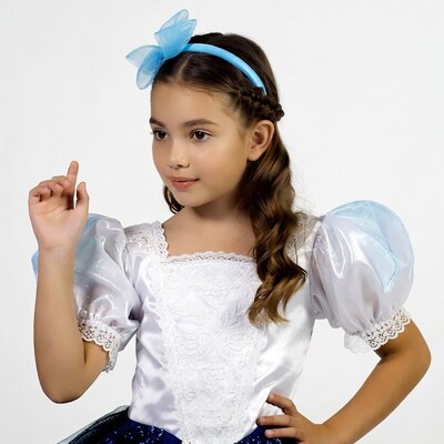Girl in blue bow dress pointing