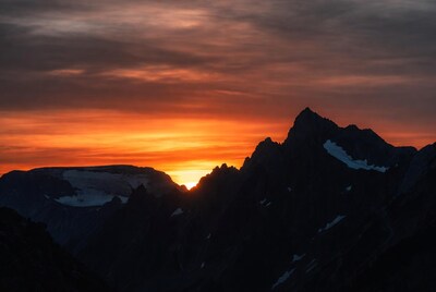 Sunset Behind Snowy Mountains
