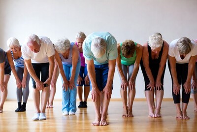 Seniors doing forward bend yoga