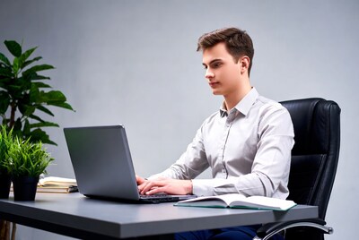 Young man working on laptop at desk