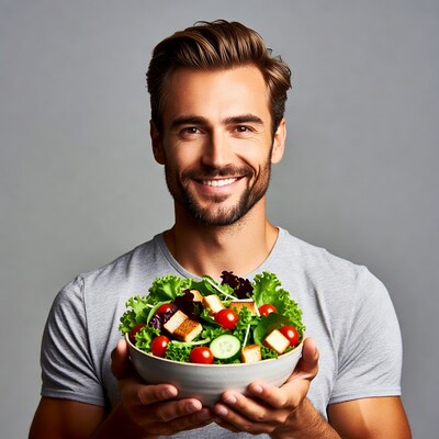 Man holding fresh salad bowl