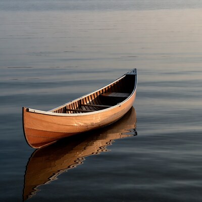Wooden canoe on calm lake