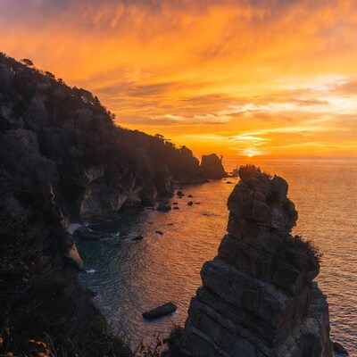 Sunset over rocky cliffs and ocean