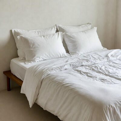 White Bed with Pillows on Wooden Frame