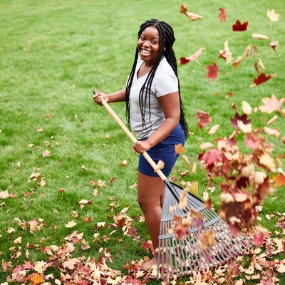 African-American girl raking leaves