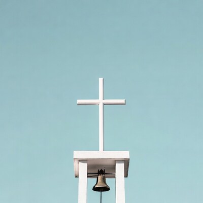 White Cross and Bell on Blue Sky