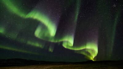 Vibrant Northern Lights over Hills