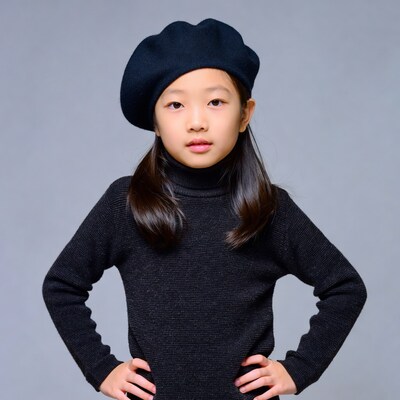 Asian girl in beret with hands on hips