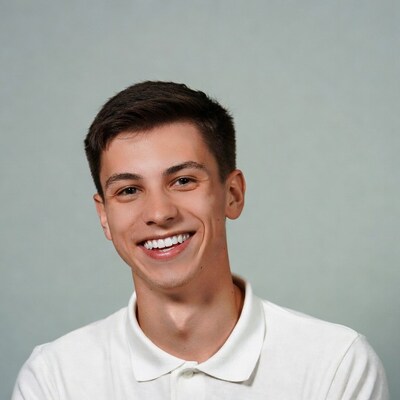 Smiling young man in white polo