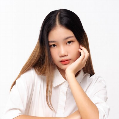 Asian girl resting chin on hand