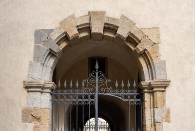Ornate Iron Gate in Stone Archway