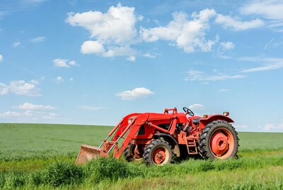 Red tractor in green field
