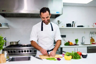 Chef chopping vegetables in kitchen