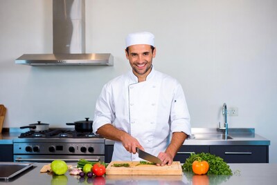 Chef chopping vegetables on kitchen counter