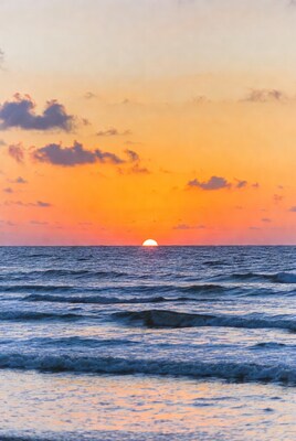 Sunset over ocean waves