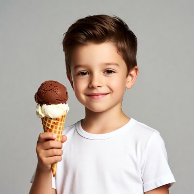 Boy holding chocolate vanilla ice cream cone
