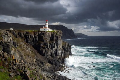 Lighthouse on stormy cliff edge