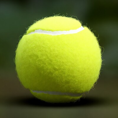 Yellow tennis ball on green background