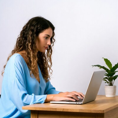 Woman typing on laptop at desk