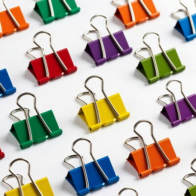 Colorful binder clips on white background
