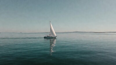 White sailboat sailing on calm sea