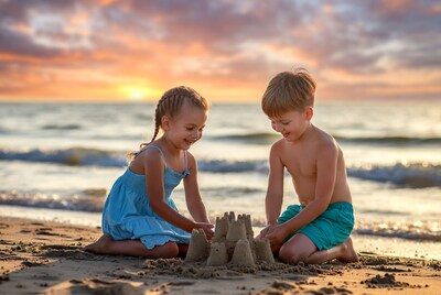 Boy and Girl Building Sandcastle at Sunset Beach