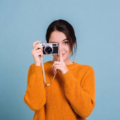 Woman peeking through vintage camera