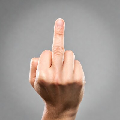 Middle finger gesture on gray background