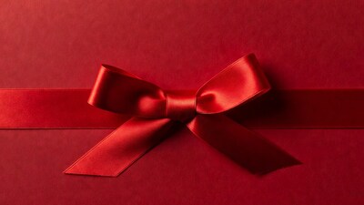 Red satin bow on red background