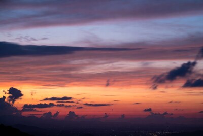 Vibrant Sunset Over Mountains and City