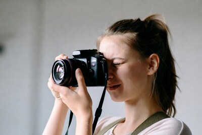 Woman looking through camera lens