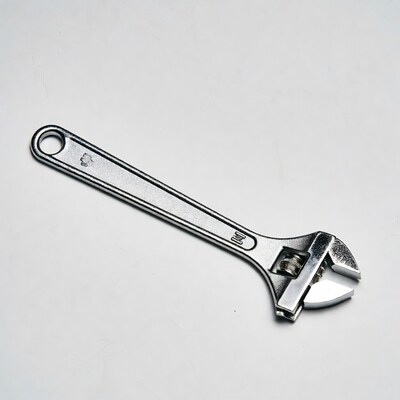 Silver adjustable wrench on white background