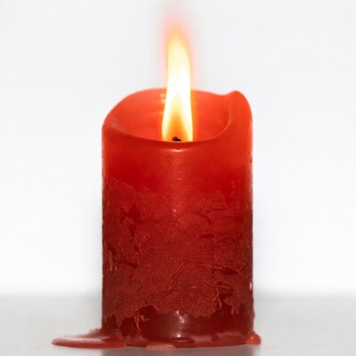 Burning Red Candle with Wax Drips