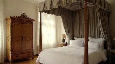 Luxurious four-poster bed with armoire