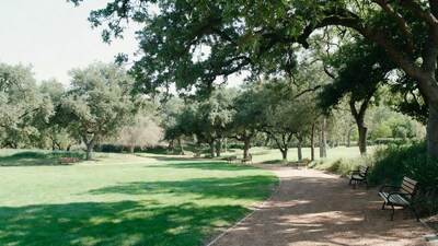 Park path with benches and oak trees
