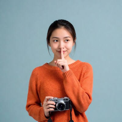 Asian woman shushing with camera